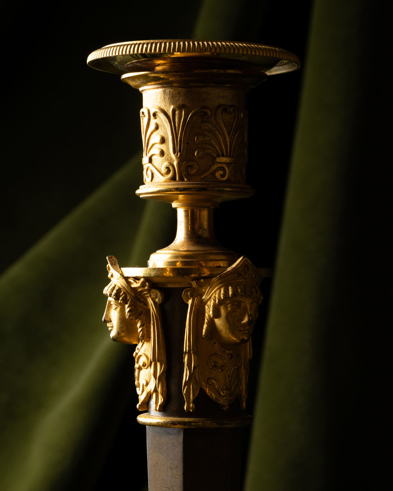 A Set of Four Empire Parcel-Gilt “Claw-Foot” Candlesticks with Antique Masks, attributed to Claude Galle
