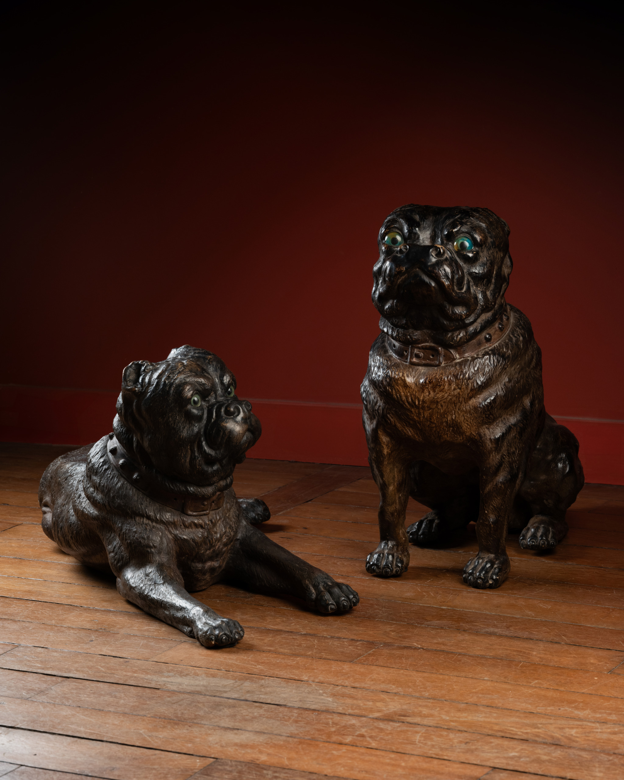 A Group of Three Painted Terracotta Pugs with Sulphide Eyes